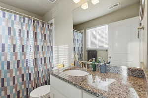 Full bathroom with vanity and a shower with curtain