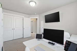 Home office with light colored carpet