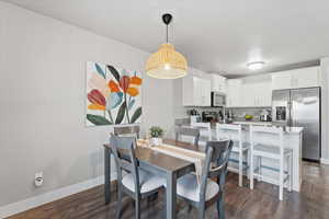 Dining space featuring dark wood-type flooring