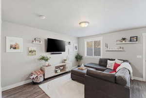Living area featuring baseboards and wood finished floors