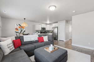 Living room featuring light wood-style flooring and baseboards