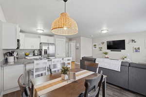 Dining room featuring dark wood-type flooring