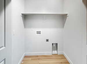 Laundry area with light wood-type flooring, washer hookup, and hookup for an electric dryer