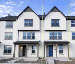 View of front of house with covered porch and stucco siding