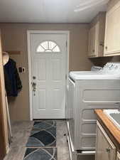Washroom with cabinet space and independent washer and dryer