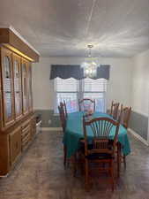 Dining area with a chandelier and baseboards