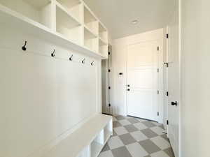 Mudroom with light floors.This is from a similar floor plan