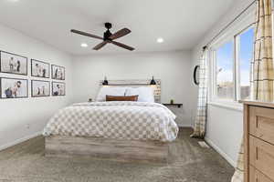Carpeted bedroom featuring a ceiling fan and recessed lighting