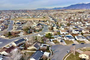 Aerial overview of property's location featuring nearby suburban area and a mountainous background