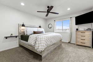 Bedroom with ceiling fan, light colored carpet, and recessed lighting