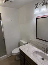 Bathroom with a shower stall and vanity