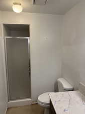 Bathroom with a shower, and a textured ceiling