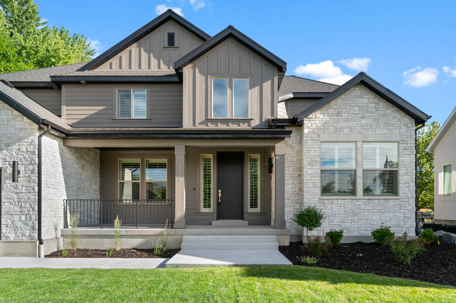 Contemporary exterior featuring stone and horizontal siding
