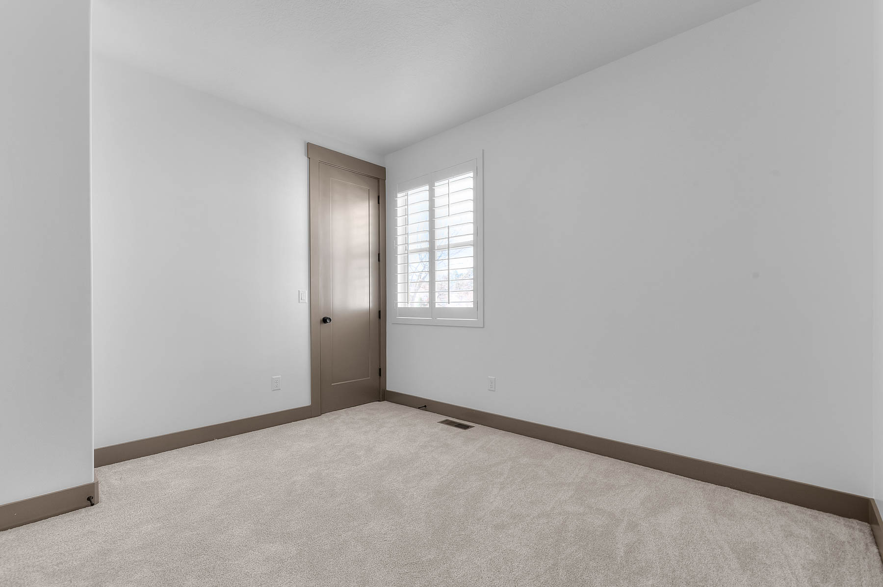 Spare room with baseboards and carpet flooring