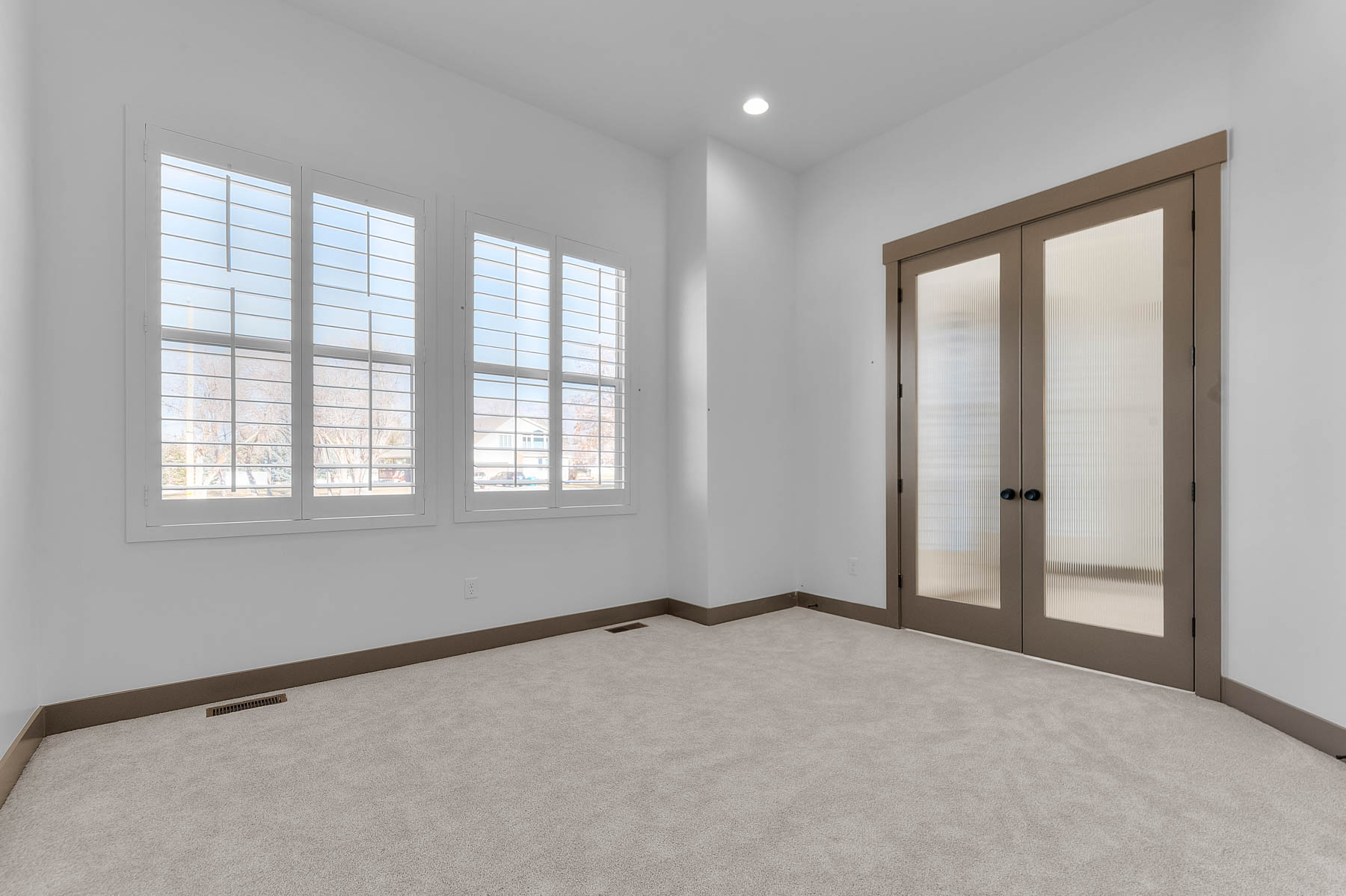 Carpeted spare room with french doors and recessed lighting