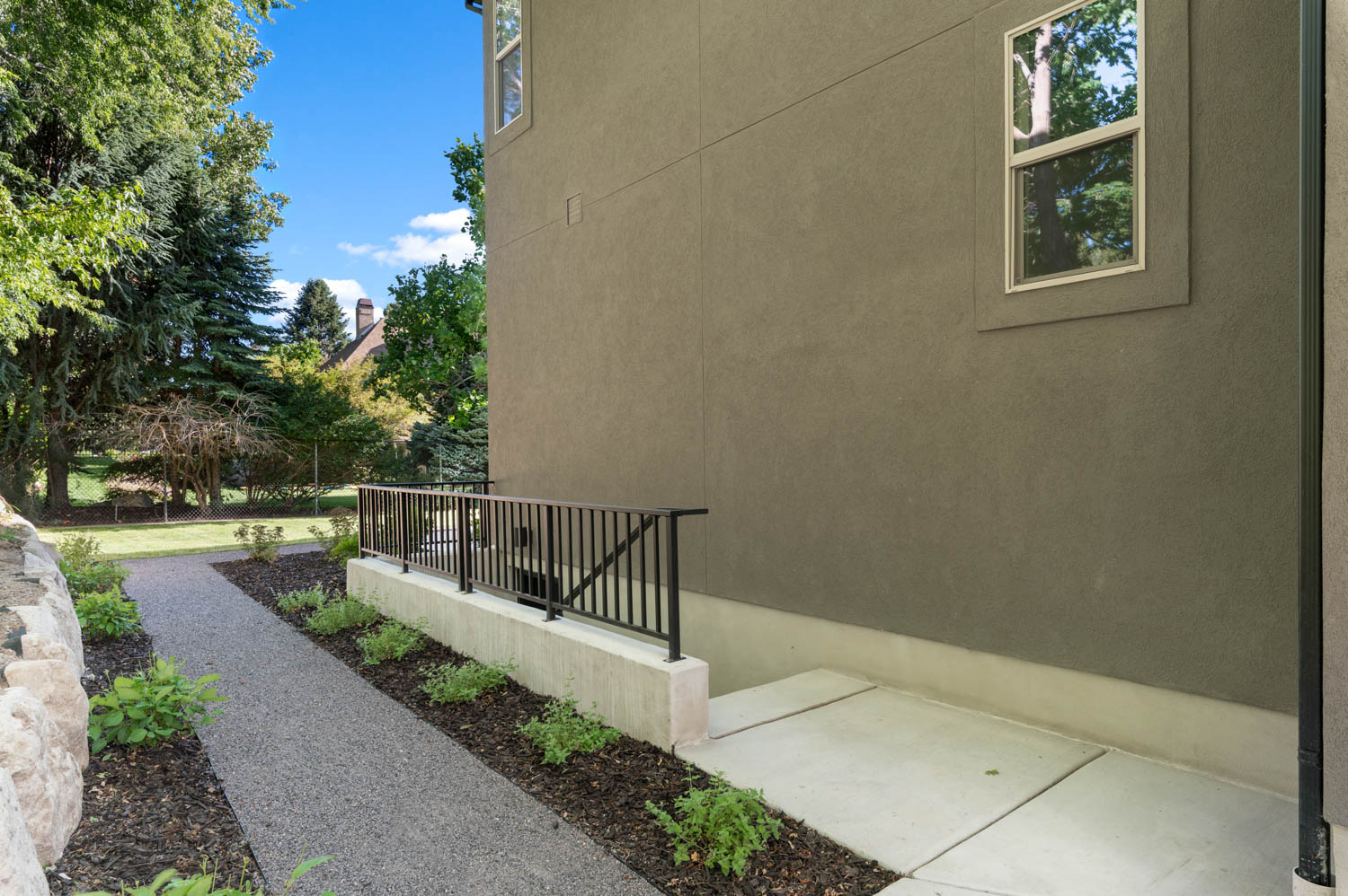 Exterior wall with stucco finish and a single window