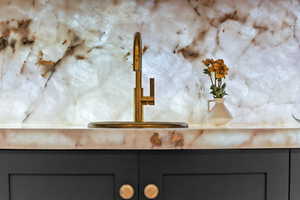 Kitchen view of a sink and gray cabinetry