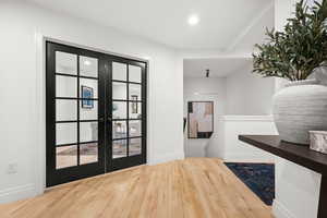 Foyer entrance with hardwood / wood-style floors, french doors, and recessed lighting