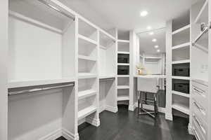 Master Walk in closet featuring dark wood-style floors