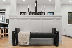 Detailed view of recessed lighting, wood finished floors, and a chandelier