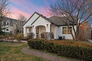 View of front of property featuring stucco siding and a chimney