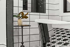 Bathroom view of tile walls and a shower