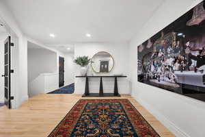 Hall featuring light wood-style flooring and recessed lighting