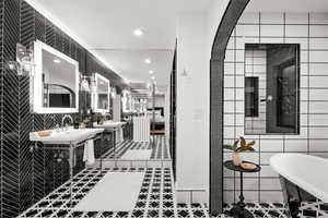 Master Bathroom featuring tile walls, recessed lighting, a soaking tub, tiled shower, and tile patterned floors
