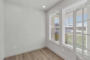 Unfurnished room with light wood-style floors and recessed lighting