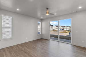 Unfurnished room featuring a ceiling fan, light wood finished floors, and recessed lighting