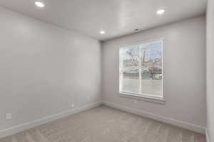 Unfurnished room featuring light colored carpet and recessed lighting