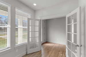 Empty room featuring light wood-style flooring and recessed lighting
