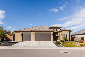 View of front of home with stucco siding, a garage, concrete driveway, a tile roof, and stone siding