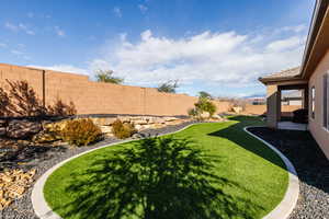 Fenced backyard with a patio area