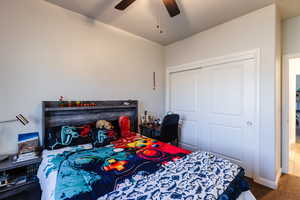 Bedroom featuring a closet, a ceiling fan, and carpet floors