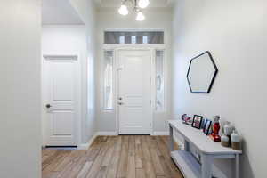 Entrance foyer featuring light wood-style flooring and a chandelier