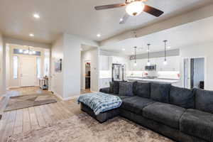 Living area featuring wood tiled floors, recessed lighting, and a ceiling fan