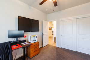 Carpeted office with baseboards and ceiling fan
