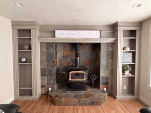 Detailed view of built in shelves and wood stove
