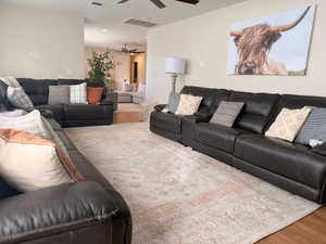 Living room with LVP floors and a ceiling fan