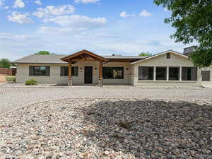 Single story home featuring brick siding and a patio