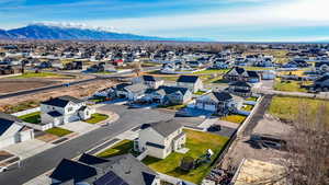 Aerial perspective of suburban area featuring a mountainous background