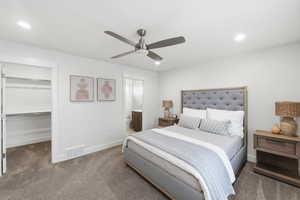 Bedroom featuring carpet flooring, a spacious closet, a ceiling fan, recessed lighting, and ensuite bath