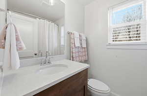 Full bath featuring vanity and a shower with shower curtain