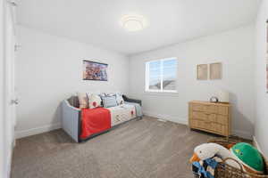 Carpeted bedroom featuring baseboards