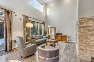 Living area with wood finished floors and a high ceiling