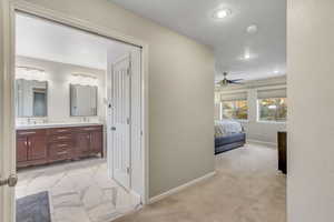Bedroom featuring light marble finish flooring, ceiling fan, light colored carpet, and recessed lighting