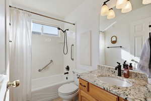 Bathroom featuring vanity and shower / bath combo with shower curtain
