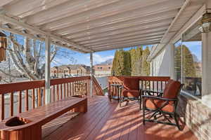Wooden terrace with a residential view and outdoor dining area