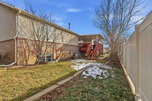 Fenced yard with a deck and stairs